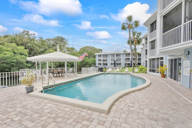 pool with a patio area and a gazebo