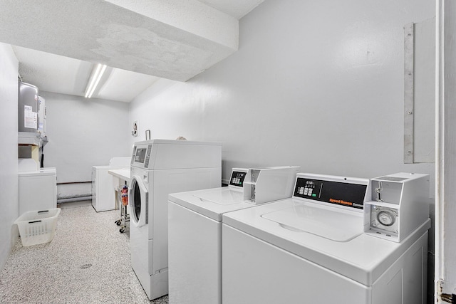 common laundry area with washer and clothes dryer and a textured ceiling