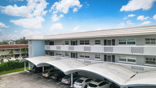 view of building exterior with covered parking