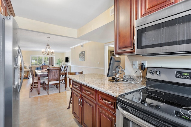 kitchen featuring stainless steel appliances, visible vents, hanging light fixtures, an inviting chandelier, and light stone countertops