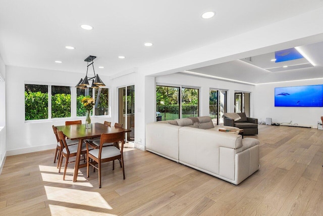 living area with recessed lighting, light wood-type flooring, and baseboards