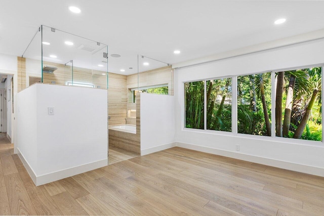 empty room featuring recessed lighting, light wood-style floors, and baseboards