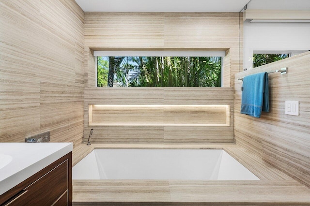 full bathroom with a garden tub and vanity