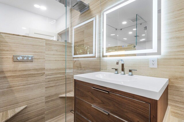 full bathroom with vanity and tiled shower