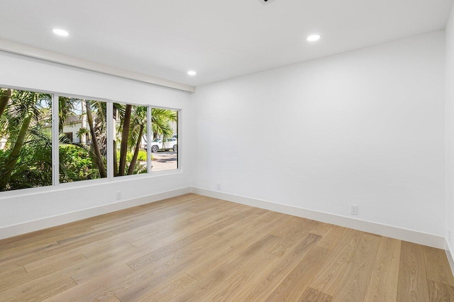 empty room featuring recessed lighting, light wood-style floors, and baseboards