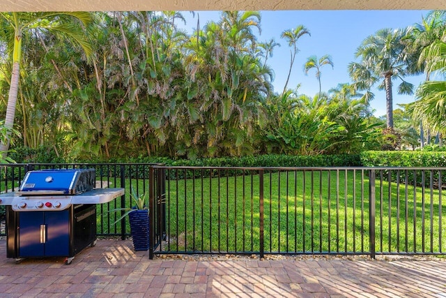 view of patio with a grill and fence