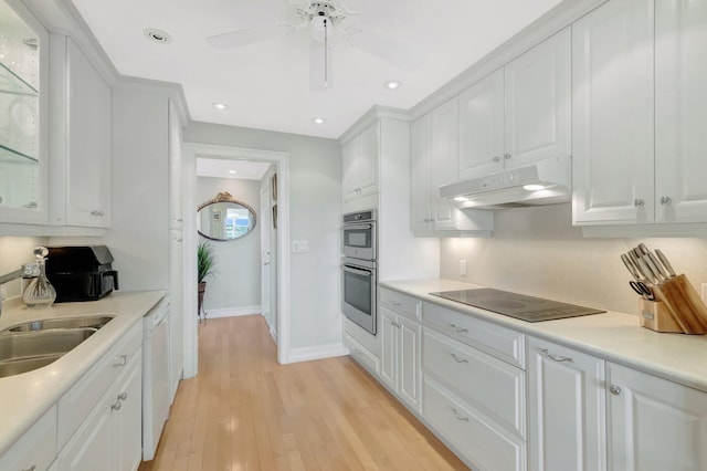 kitchen featuring stainless steel double oven, white cabinets, white dishwasher, under cabinet range hood, and black electric cooktop