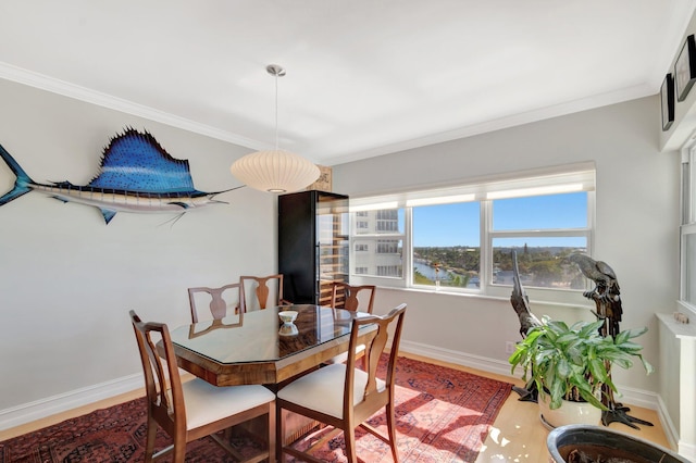 dining space with crown molding and baseboards