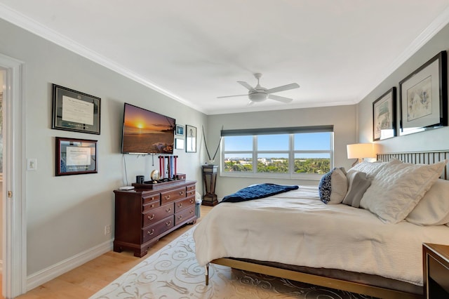 bedroom featuring ornamental molding, ceiling fan, light wood-style flooring, and baseboards