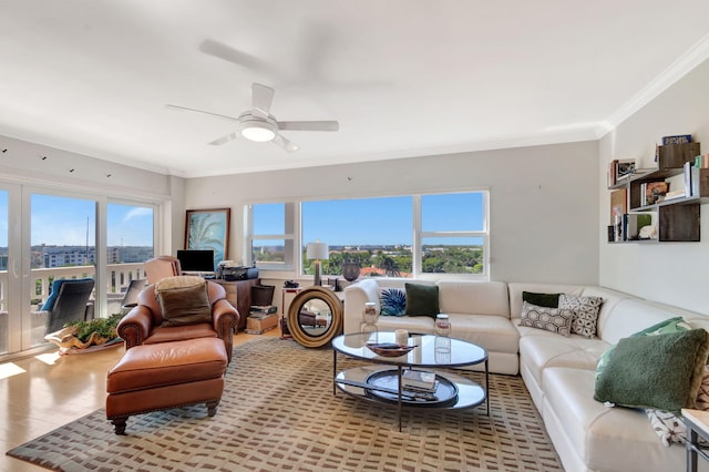 living room with ceiling fan, ornamental molding, wood finished floors, and a healthy amount of sunlight