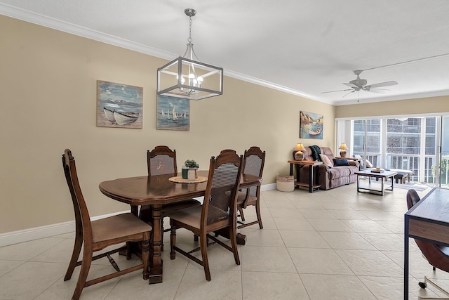 dining area with light tile patterned flooring, ceiling fan with notable chandelier, baseboards, and ornamental molding