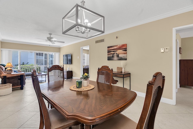 dining area featuring visible vents, crown molding, baseboards, light tile patterned floors, and ceiling fan with notable chandelier