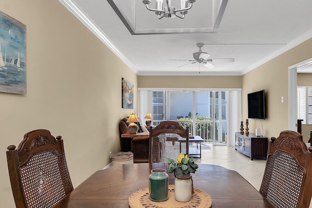 dining area with light tile patterned floors, ceiling fan with notable chandelier, and ornamental molding