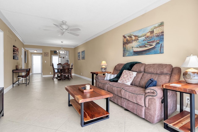 living room featuring crown molding, light tile patterned floors, baseboards, and ceiling fan