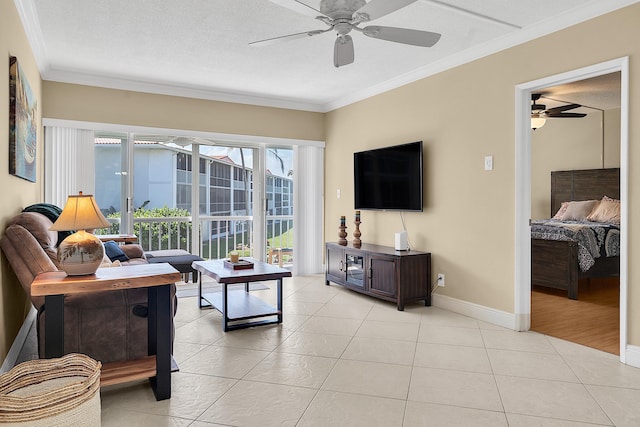 living area with crown molding, light tile patterned flooring, baseboards, and ceiling fan