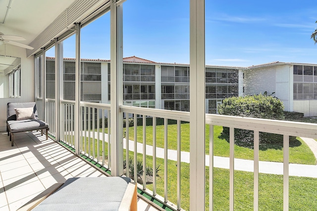 unfurnished sunroom with ceiling fan