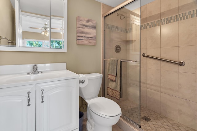 full bathroom featuring a shower stall, toilet, vanity, and a ceiling fan