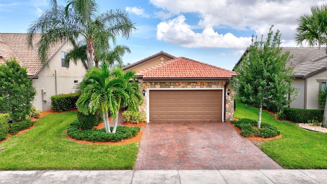 view of front of property with a garage, stone siding, a tile roof, decorative driveway, and a front lawn