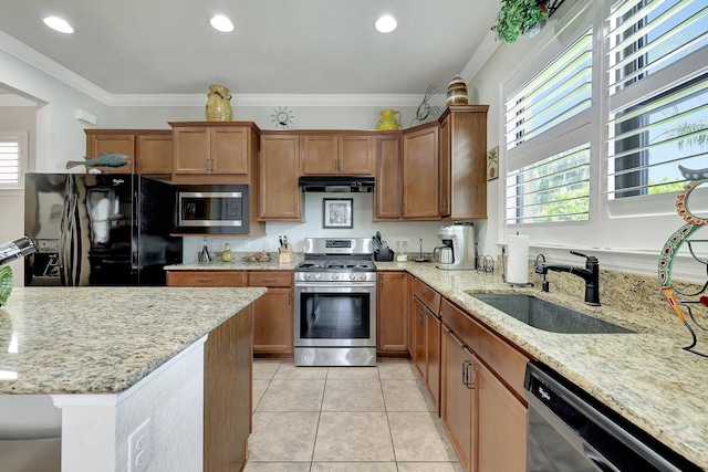 kitchen featuring crown molding, stainless steel appliances, light tile patterned flooring, a sink, and under cabinet range hood