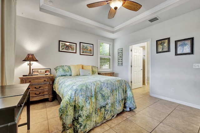 bedroom featuring light tile patterned floors, baseboards, visible vents, a tray ceiling, and crown molding