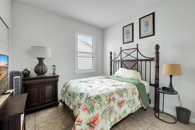 tiled bedroom featuring baseboards