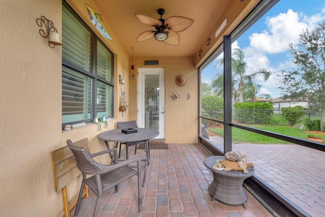 sunroom / solarium with a ceiling fan and a wealth of natural light