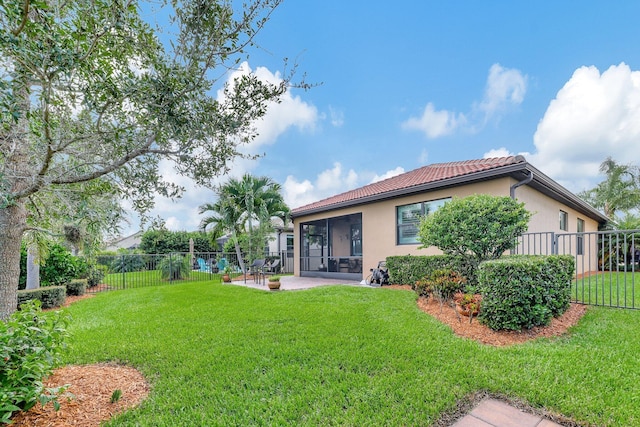 back of property with a lawn, a patio area, a fenced backyard, and stucco siding