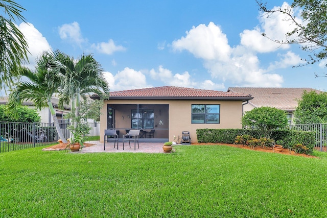 rear view of house with a patio area, a fenced backyard, a lawn, and stucco siding