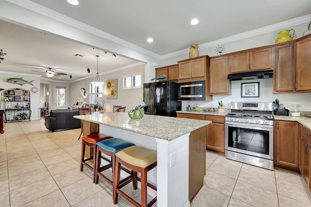 kitchen with stainless steel appliances, brown cabinets, and range hood