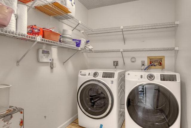 laundry area featuring laundry area, baseboards, and separate washer and dryer