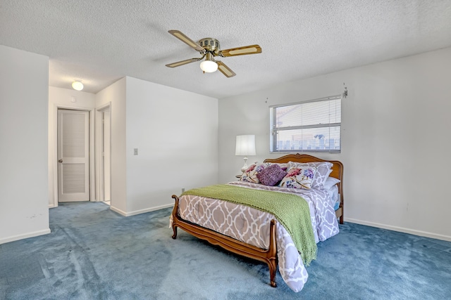 carpeted bedroom featuring baseboards, a textured ceiling, and a ceiling fan