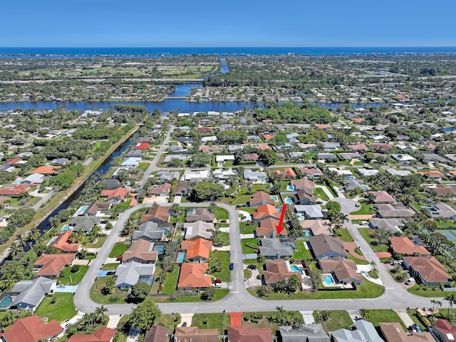 birds eye view of property with a water view and a residential view