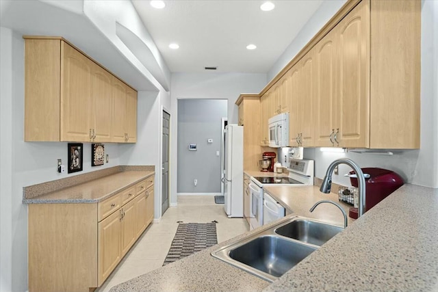 kitchen featuring recessed lighting, white appliances, light brown cabinets, and light tile patterned floors