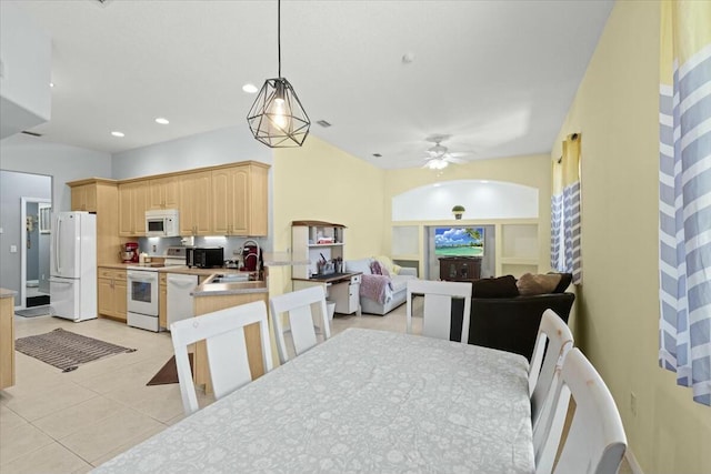 kitchen featuring white appliances, light countertops, light brown cabinets, a sink, and light tile patterned flooring