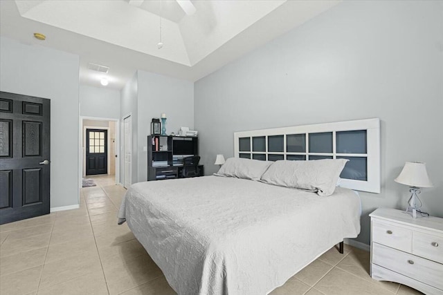 bedroom with baseboards, visible vents, lofted ceiling, a closet, and light tile patterned flooring