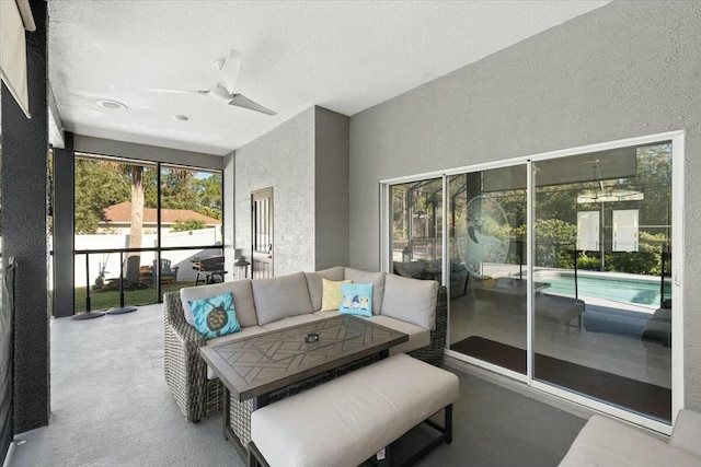 sunroom / solarium featuring a ceiling fan