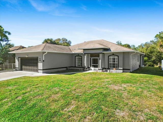 view of front of house with stucco siding, a shingled roof, concrete driveway, an attached garage, and a front yard