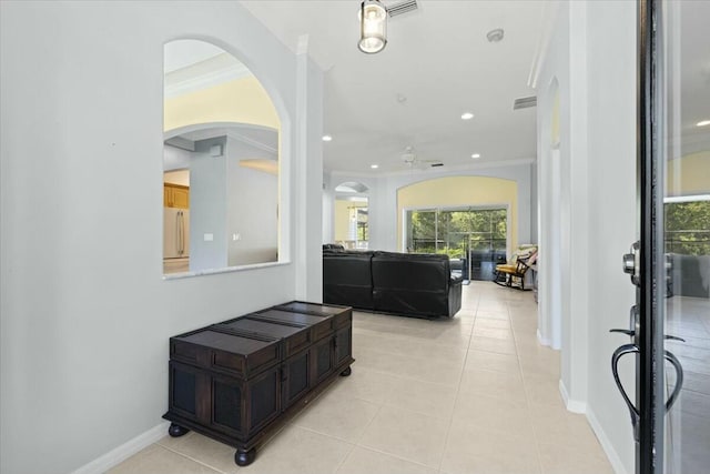 foyer featuring light tile patterned floors, baseboards, crown molding, and recessed lighting