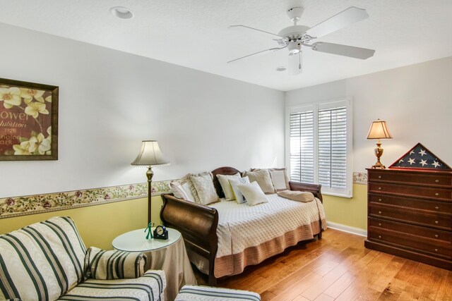 bedroom featuring baseboards, ceiling fan, and hardwood / wood-style floors