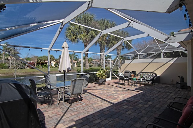 view of patio / terrace with area for grilling and a lanai