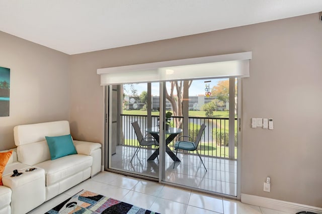 doorway to outside with light tile patterned flooring and baseboards