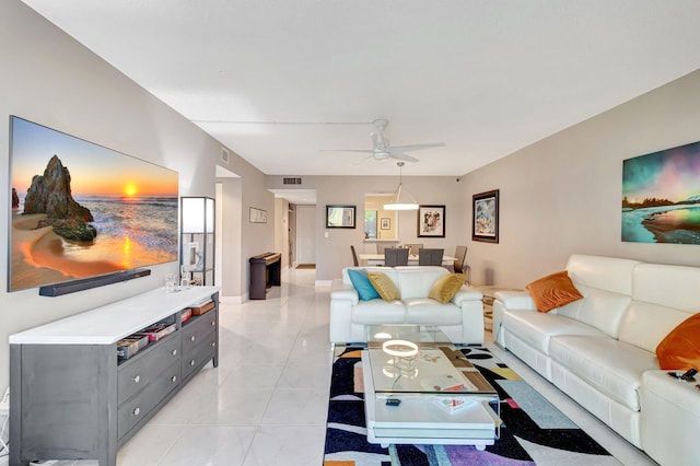 living room featuring light tile patterned floors, ceiling fan, and visible vents