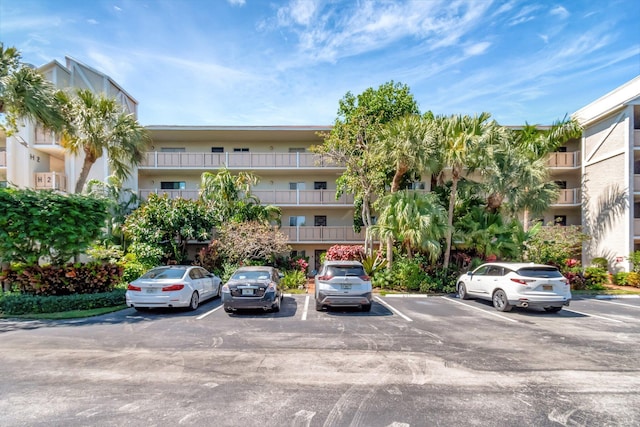 view of building exterior with uncovered parking