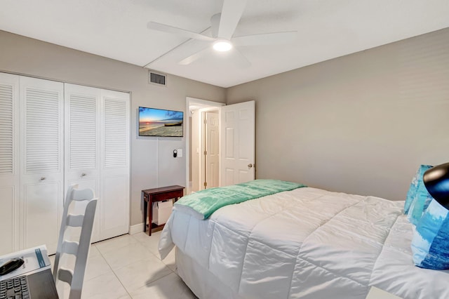 bedroom with a ceiling fan, a closet, visible vents, and light tile patterned flooring