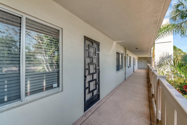 exterior space with a balcony and stucco siding