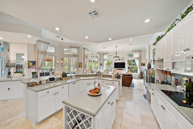 kitchen with visible vents, dishwasher, a large island, open floor plan, and black electric cooktop