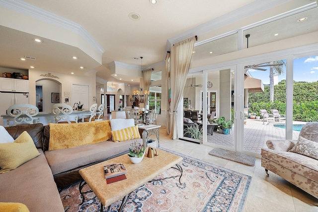 living room featuring light tile patterned floors, recessed lighting, arched walkways, and ornamental molding