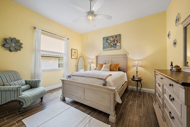 bedroom with ceiling fan, wood finish floors, and baseboards