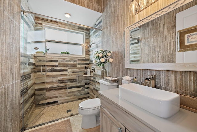 bathroom with a stall shower, tile patterned flooring, vanity, and toilet