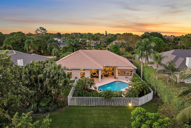 exterior space with a fenced in pool, a fenced backyard, a yard, and a patio